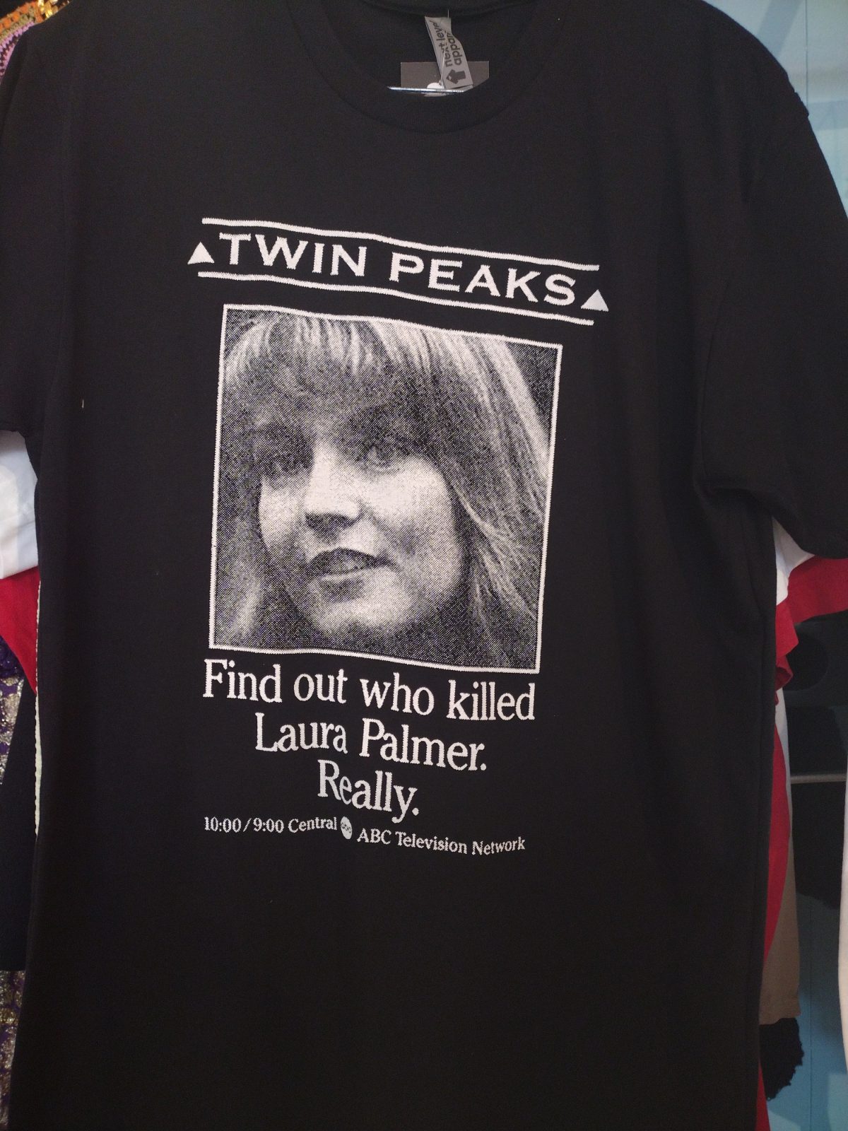 Black t-shirt with "Twin Peaks" and "Find out who killed Laura Palmer. Really." text.